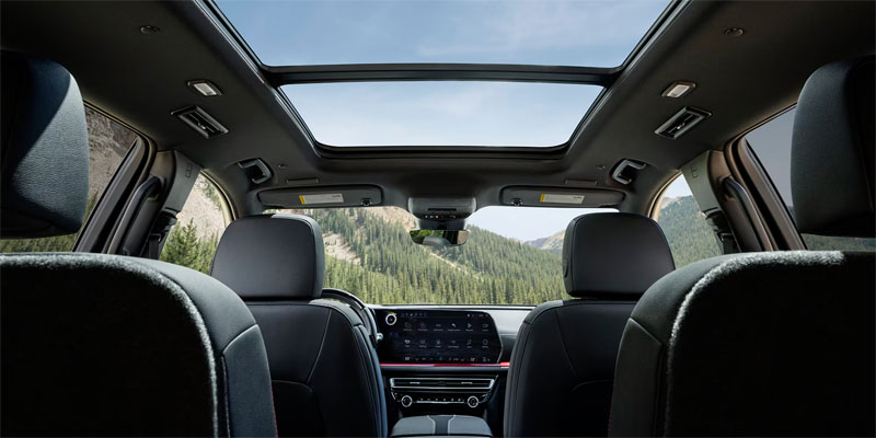 2026 Chevrolet Traverse interior roof view with panoramic sunroof and touchscreen display, highlighting its modern technology and spacious cabin design.